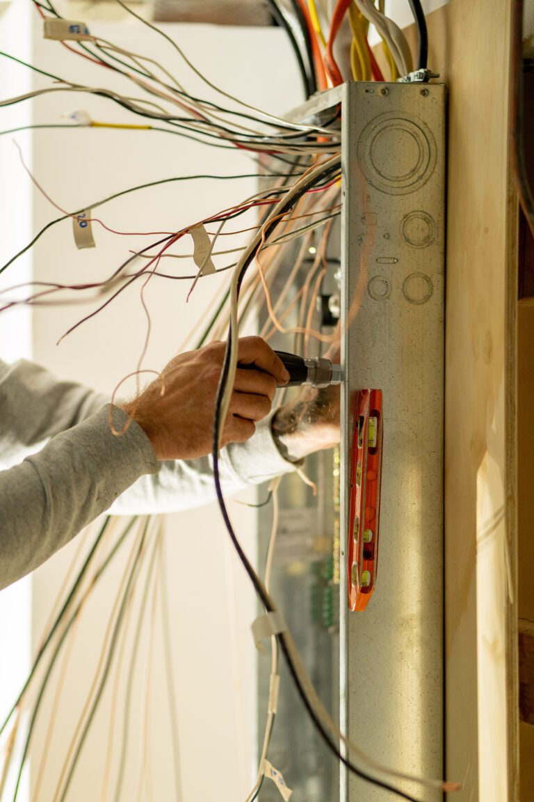 Electrician wiring a new service panel