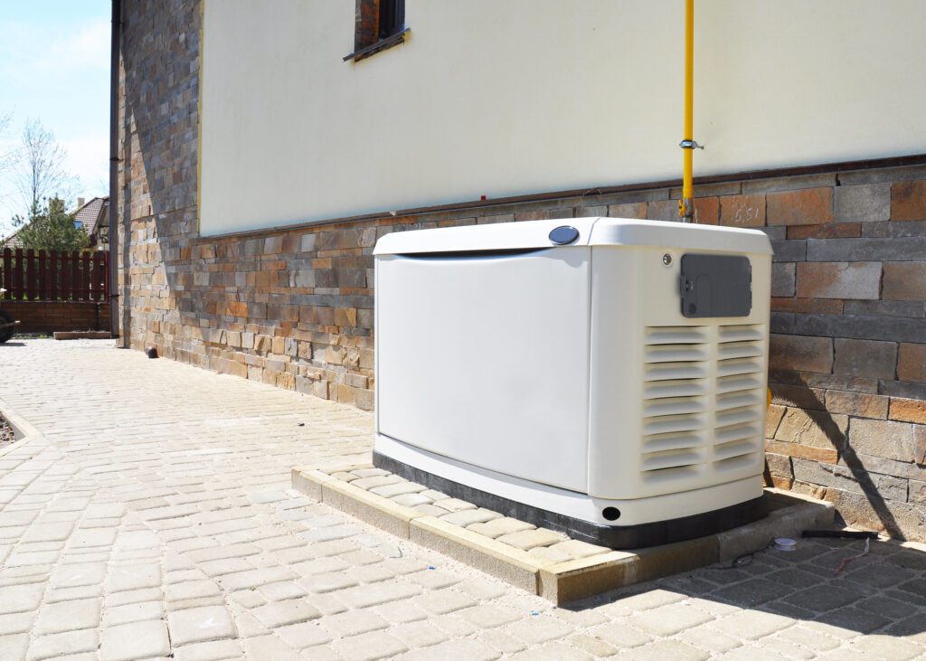 Whole-home standby generator installed beside a house