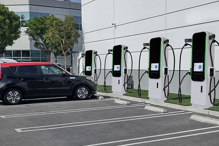 Row of commercial EV charging stations in a parking lot