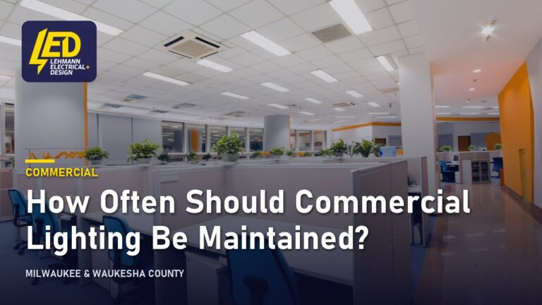 Modern commercial office with cubicles, blue chairs and recessed ceiling lights, titled How Often Should Commercial Lighting Be Maintained?