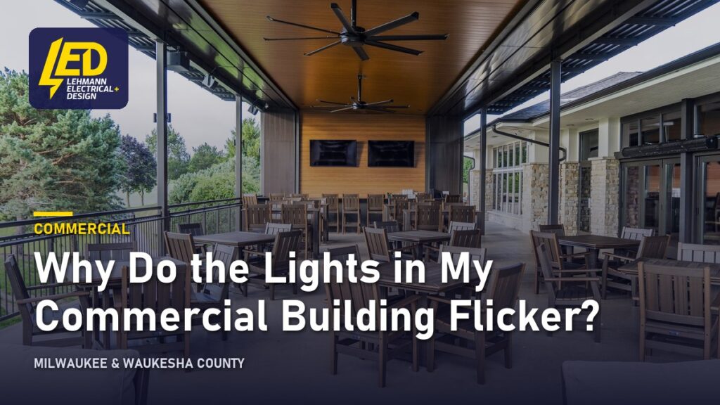 Commercial patio with ceiling fans and lighting under a covered structure, titled Why Do the Lights in My Commercial Building Flicker?