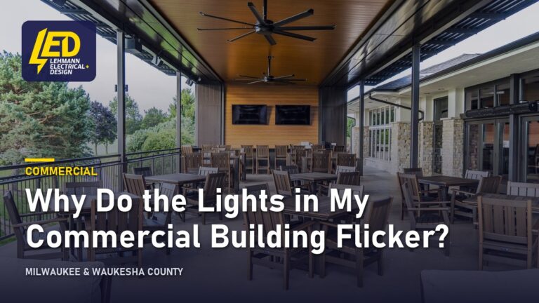 Commercial patio with ceiling fans and lighting under a covered structure, titled Why Do the Lights in My Commercial Building Flicker?