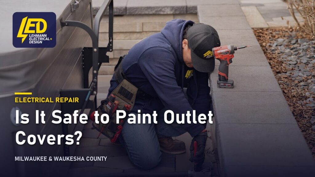 Lehmann Electrical technician installing an outdoor electrical outlet on a residential deck railing, titled Is It Safe to Paint Outlet Covers?